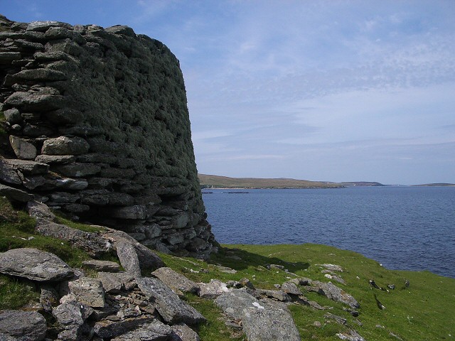 This broch stands about 12 feet high on the seaward side, overlooking Bluemull Sound, although it has tumbled down on the landward side.

Copyright Lis Burke and licensed for reuse under this Creative Commons Licence.