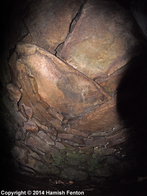 Photograph of the roof and back wall of Wadbister souterrain.

Photograph taken using a fisheye lens (very wide and somewhat distorted view).

14 September 2014