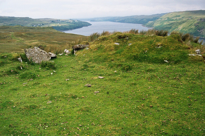 Dun Merkadale Not much left of this fort but a few scattered stones and a couple of flat oval shaped areas, however, the site has to be admired, if only for it's magnificent view over Loch Harport. Access is reasonably easy via a track which leads through what appears to be a dumping ground for old cars, fridges etc. but all this is mitigated by the surrounding scenery.
OS NG 390 306