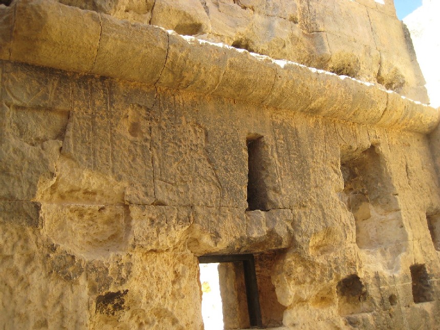 It was also know as the temple of the oracle and is most famous for confirm Alexander The Great as the Sun of Amun /Zeus and the King of Egypt.
Here a view of the holy of the holies with tourists for scale where some reliefs survive. The burn marks are from Beduin fires over the last 2 Milenia.