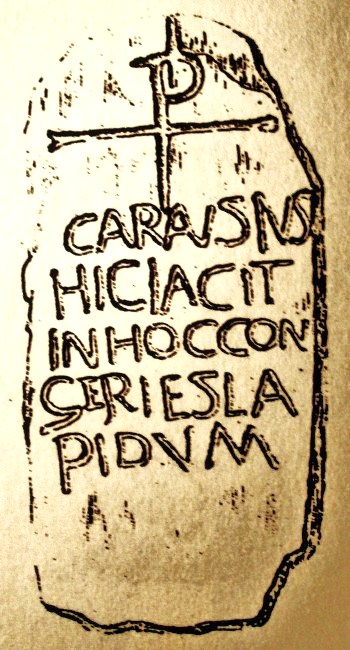 Illustration of The Carausius Stone or grave-slab in St Tudclud's church. It dates from the 5th century and recalls Crair or Caron, a 3rd century king. The stone originally stood in a field close to the church, but it was brought into the church when it's importance became clear. It has a Greek chi rho cross and a Latin inscription carved on it.