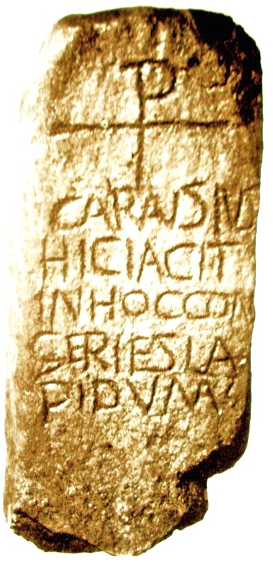 The Carausius Stone dates from the 5th century and commemorates Crair or Caron, a 3rd century Irish shepherd- boy who became king of Ceredigion in Wales. He was honoured by the Britons as a hero who stood up to the might of Rome. Carved on the stone is the Greek chi rho cross - the Greek letters X & P forming a four-rayed cross. The Latin inscription is: CARAUSIUS HICIACIT INHOCCON GERIESLA PIDUM 