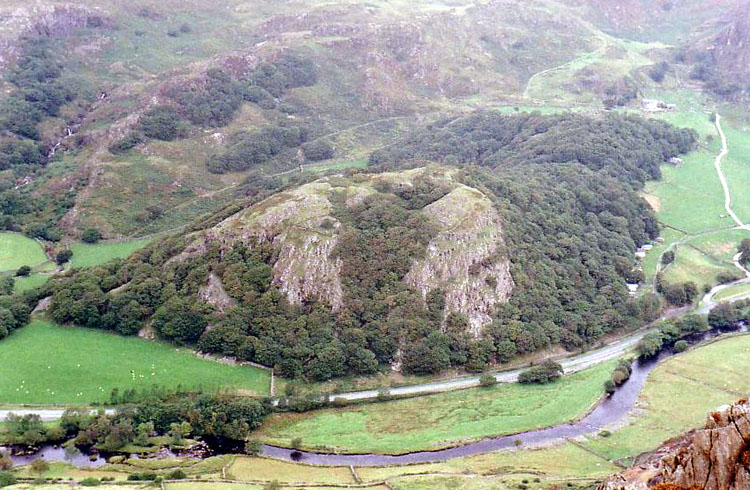 This is the hillfort of Merlin by the A498 to Beddgelert.  Here, the boy Myrddin (Merlin) told Vortigern why his fortress always collapsed.  In a pool below the hill, a red dragon and a white one fought and tumbled Vortigern's new tower.  Merlin explained that the white dragon was that of the Saxons and it would triumph.  There would then come a champion (Arthur) to lead the Red Dragon of Wales to