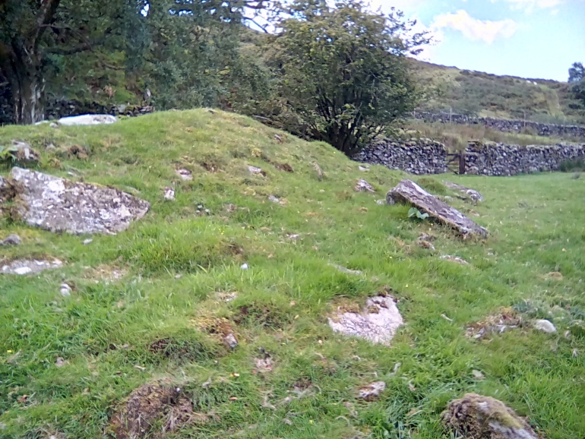 Western side of the cairn with a trackway gate leading on (upper R). 