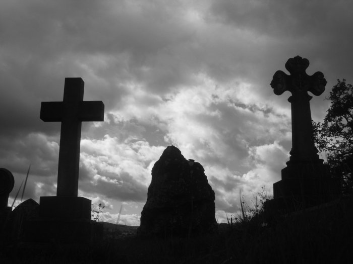 The possible standing stone at Old Radnor Church, flanked by much later memorials. Looking north.