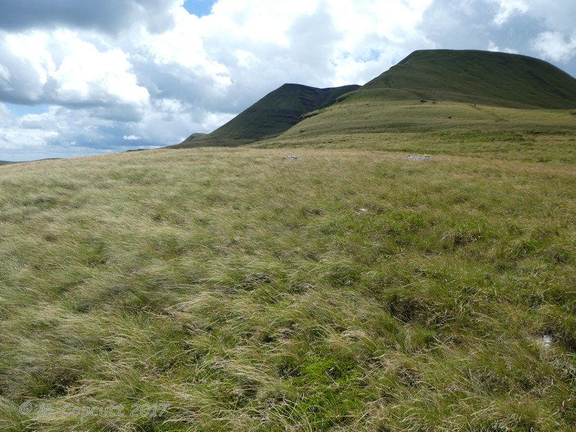 With a bit of an optimistic eye, I could make out what might be an arc of stones probably with an approx. 15 m diameter, but it may well have been no more than my wanting to see something. 

Looking towards the climb up to the summit of Fan Foel. Twr-y-Fan Foel to the left. 

