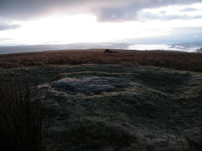 This stone lies just to the west of the circle, and although not listed as belonging, I have included it here. It is about the size of a small kitchen table, approx 4 feet across, with what looks like a ditch surrounding it. At first I though it may be just sheep type erosion, but the ditch is completely grass covered and not worn at all, unlike the usual muddy tracks made by Shawn and co. 